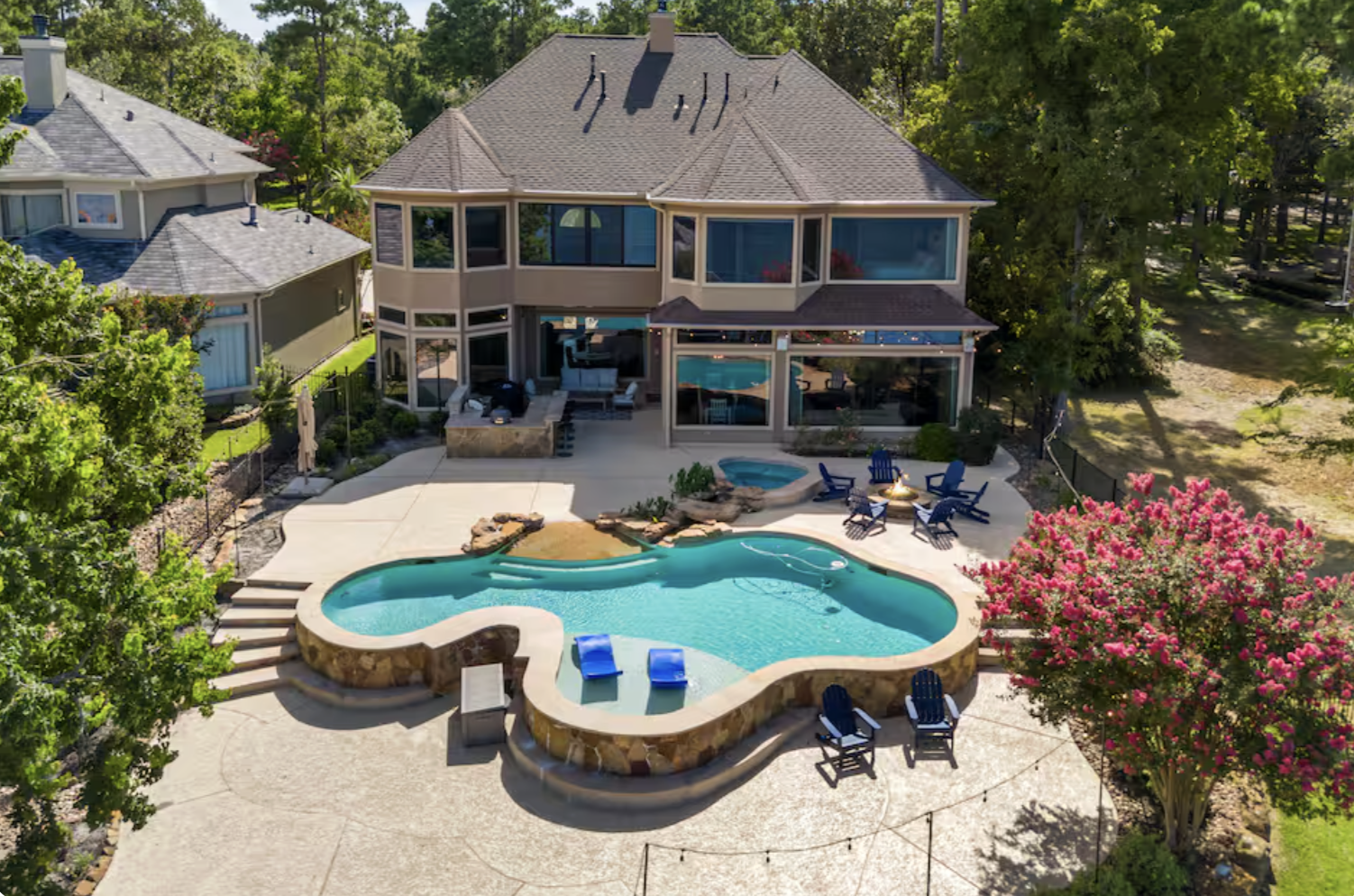 Aerial view of lakefront estate with lagoon pool
